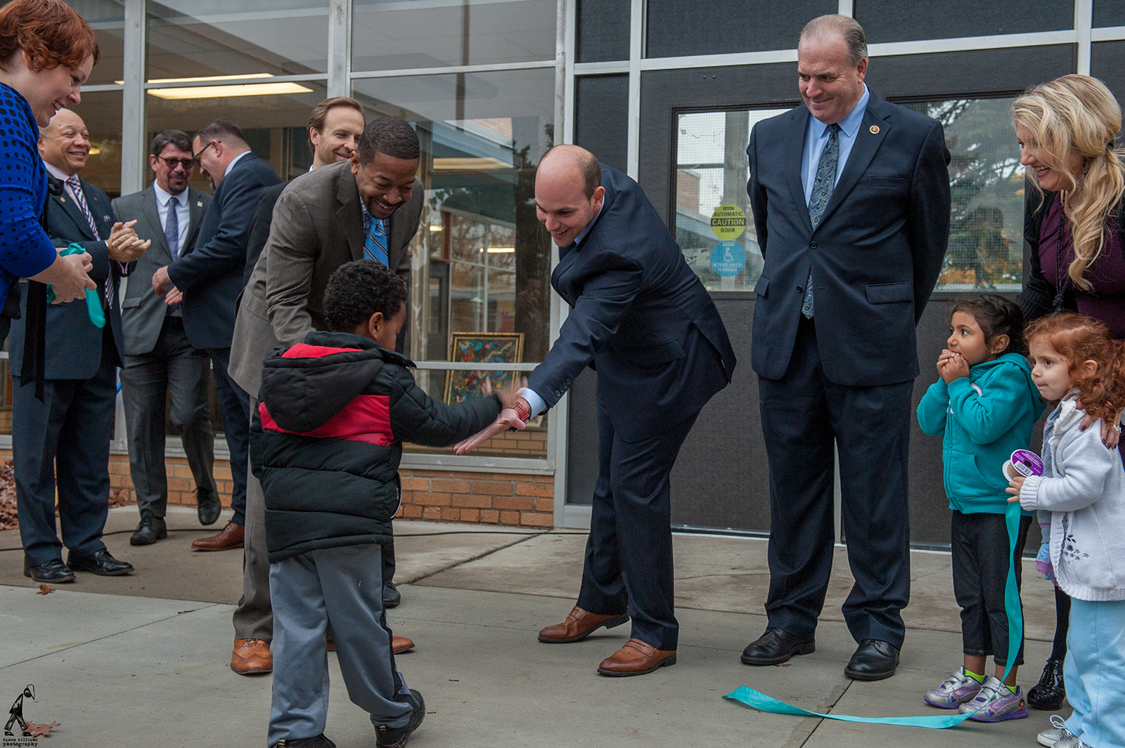 Ridgway White and a young student celebrate the opening of an early education centre in Flint, Michigan.