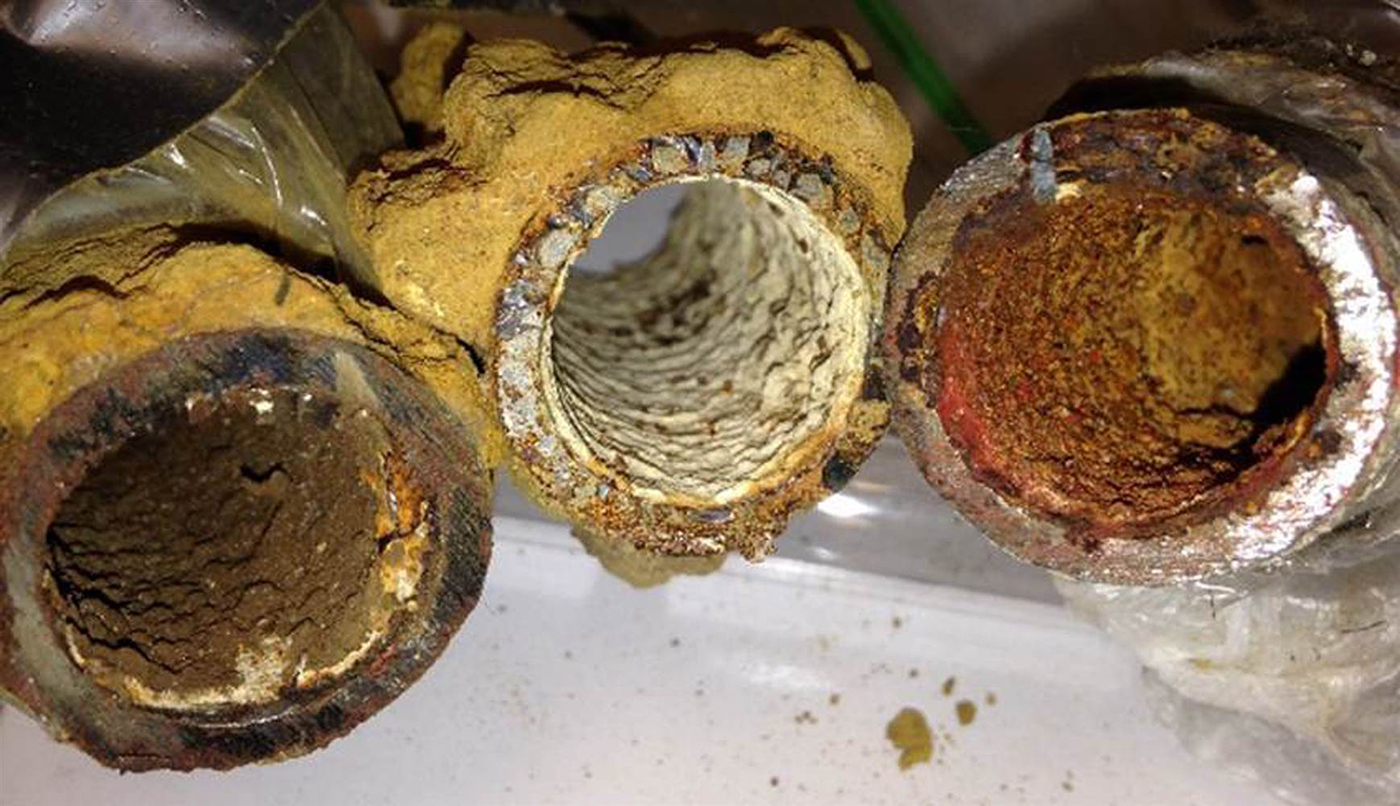 A row of corroded water pipes.