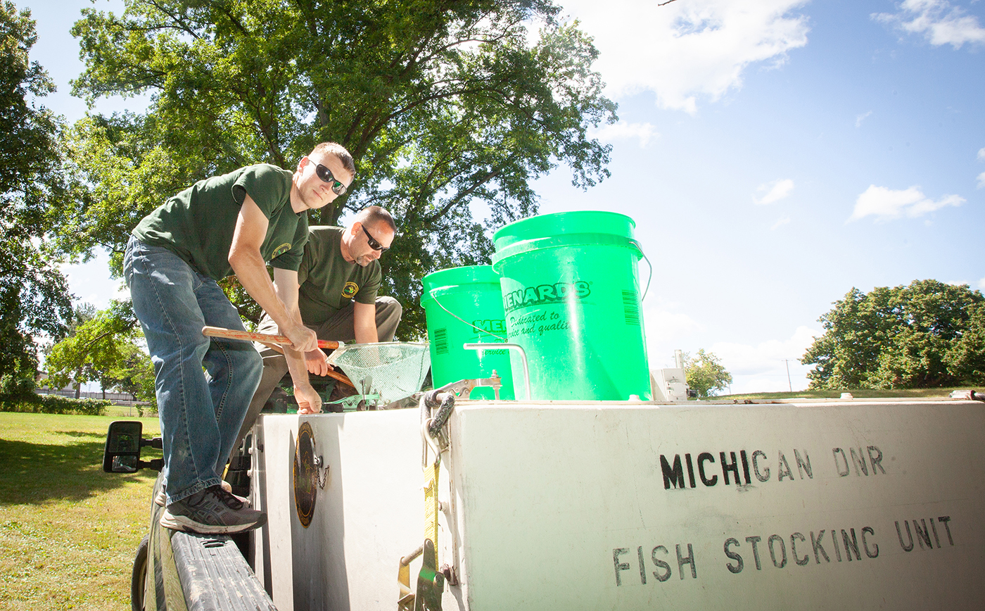 Flint River Watershed Coalition in conjunction with the Department of Natural resources restock the Flint River with sturgeon from buckets.