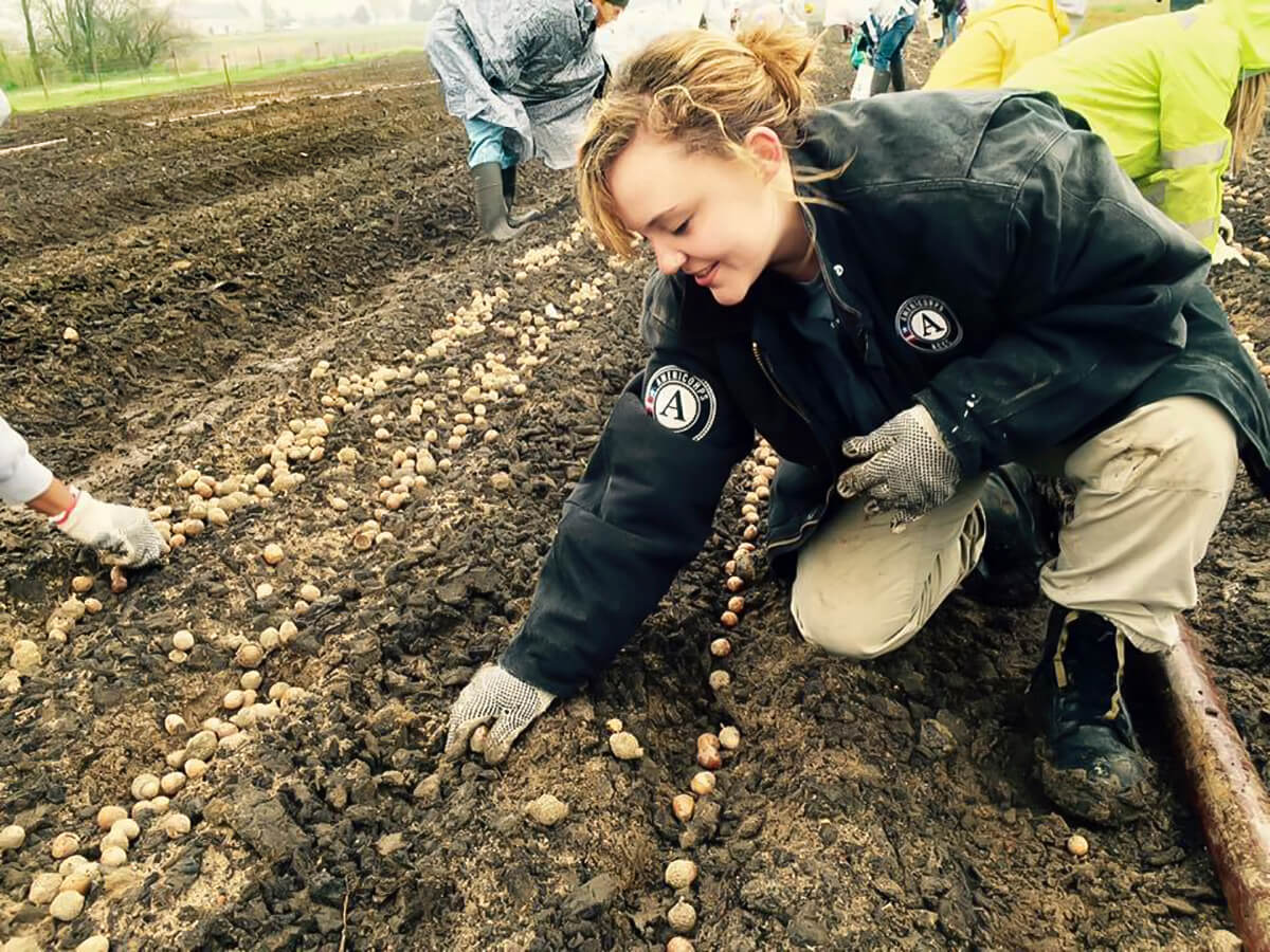 AmeriCorps NCCC member Katherine Kuhn focused on education in Flint, Michigan, and helped plant native trees and provide workshops for kids on sapling care in East Moline, Illinois.