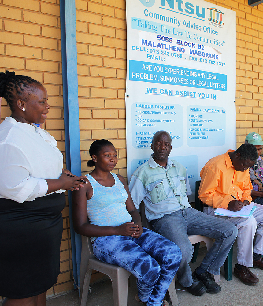 People wait in line at a community advice office.