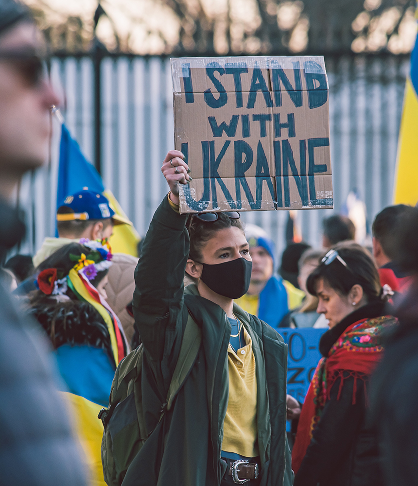 Protester holds up sign with the words "I Stand With Ukraine."