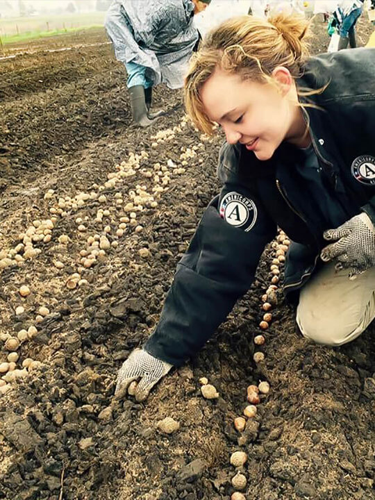 AmeriCorps NCCC member Katherine Kuhn focused on education in Flint, Michigan, and helped plant native trees and provide workshops for kids on sapling care in East Moline, Illinois.