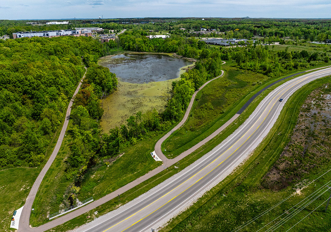 An aerial view of a trail that winds around a wetland area and is located just off of the freeway near the Henry Ford Genesys Hospital that is located in Grand Blanc Township.