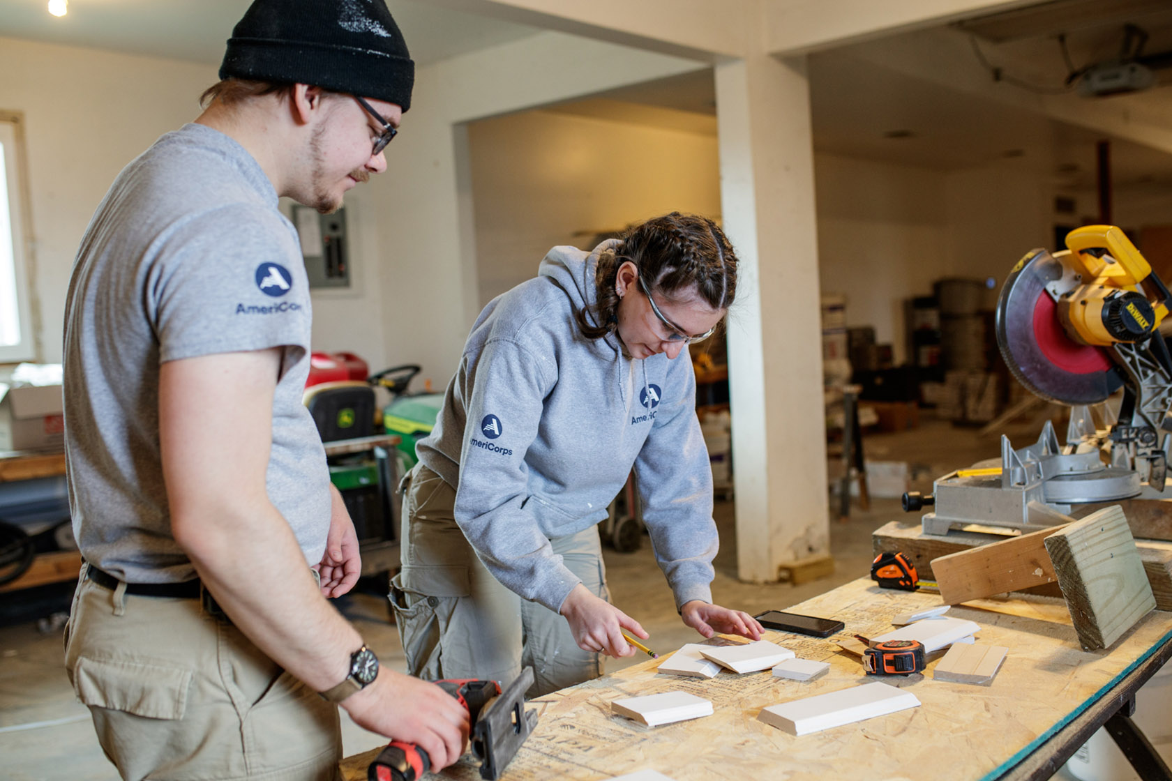 AmeriCorps NCCC service members cut wood pieces use in renovating a home in Goodrich, Michigan, to serve as transitional housing for Flint area veterans.