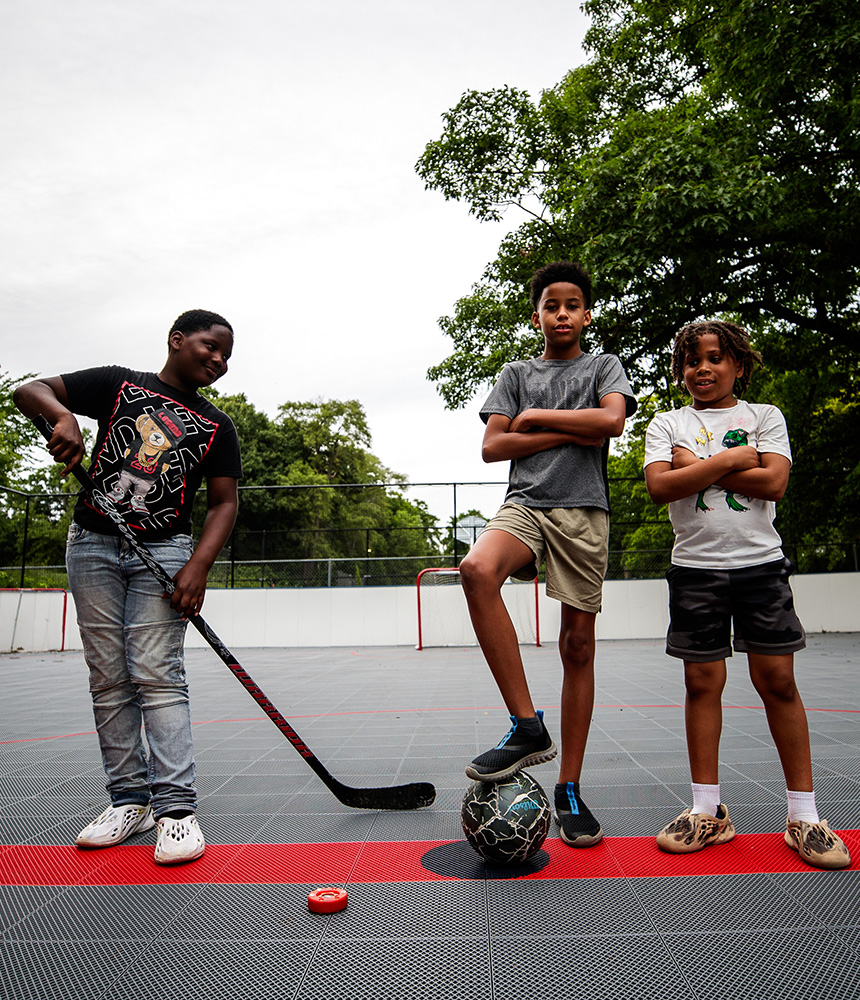 Kids at Mott Park play field hockey and soccder on a refurbished tennis court.