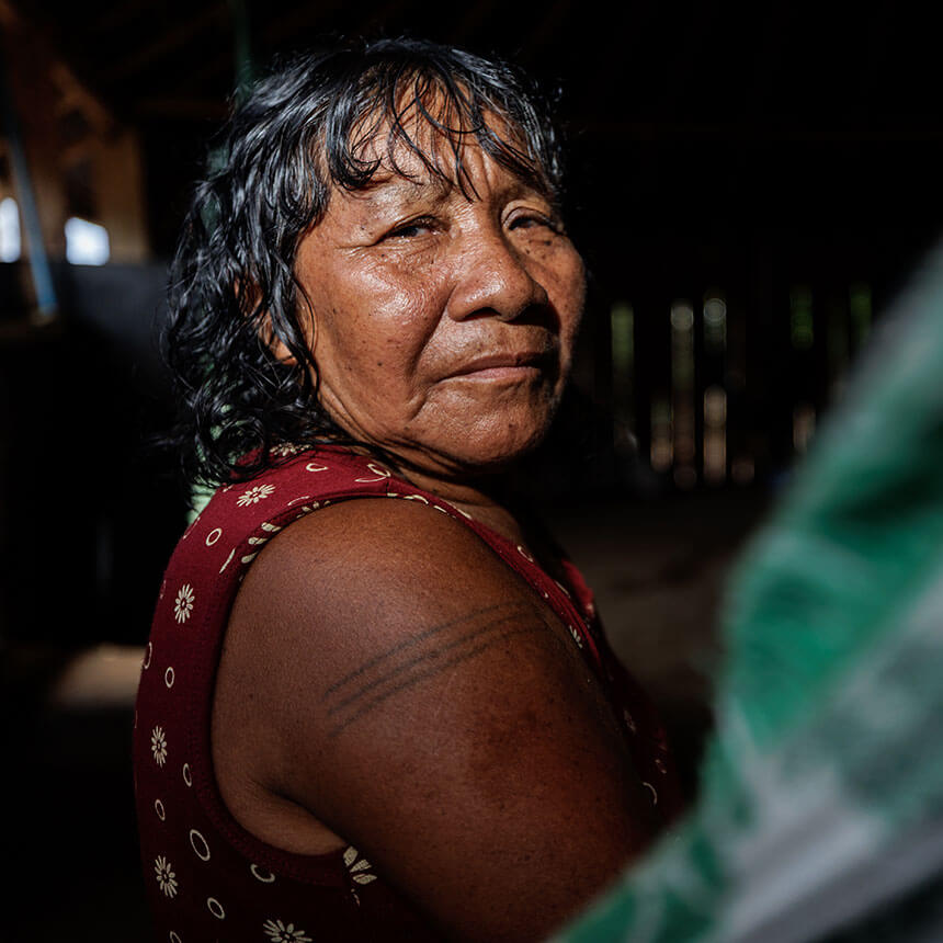 A dramatic portrait of a woman looking back over her shoulder.