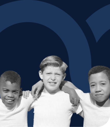 Historical image of three boys standing arm in arm.